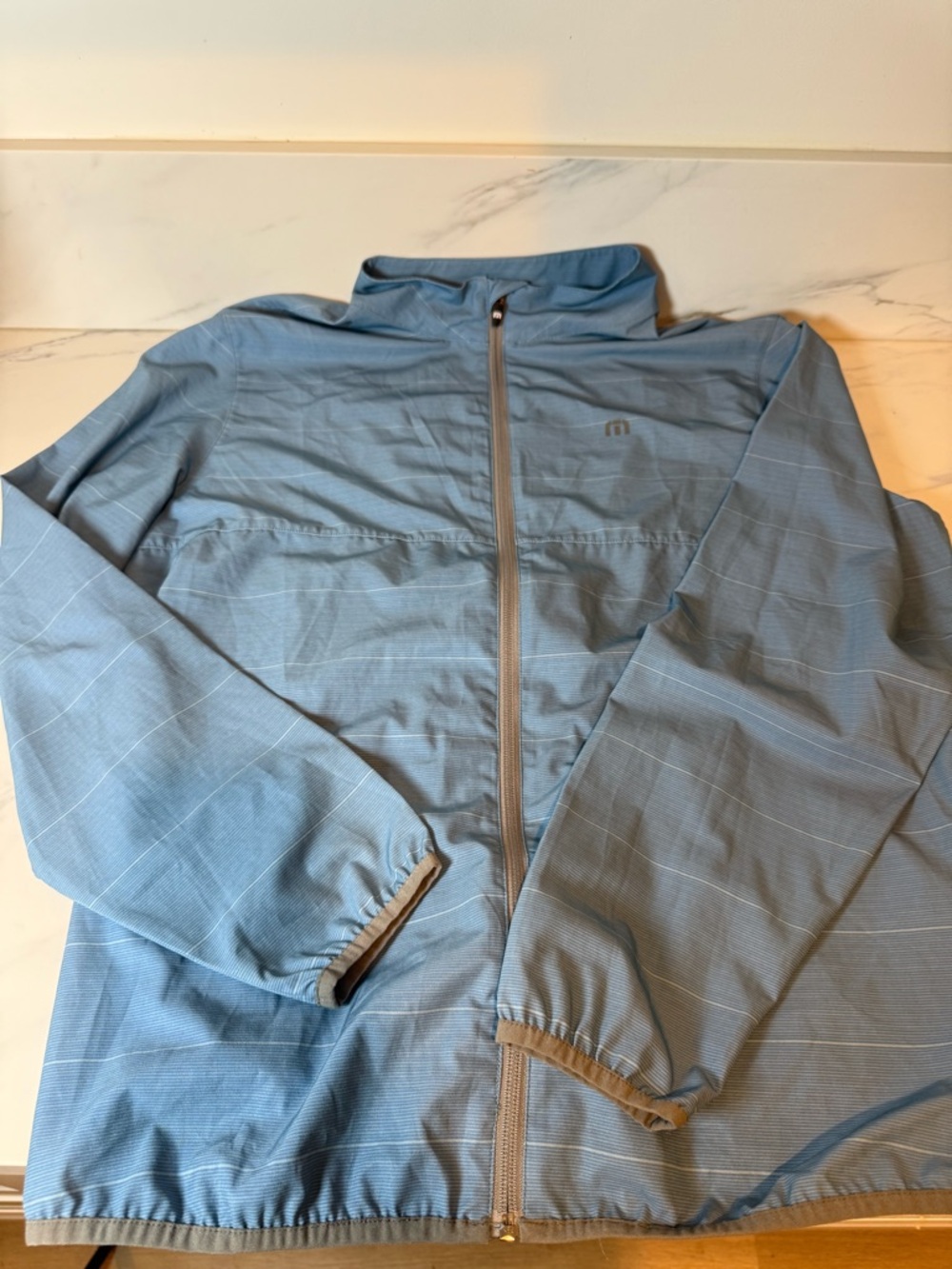 Travis Mathew blue striped windbreaker